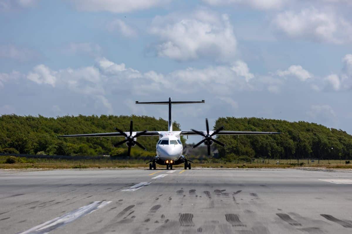Avião turbo-hélice taxiando em pista cercada por vegetação, representando a aviação regional no Brasil